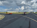 Towplane and orange glider staged for a launch.