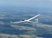 A white glider in smooth air above the Hill Country.