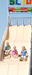 3 kids riding down a large slide