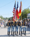 Calvary men carrying flags during a parade