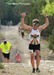 Man with his hands up in victory during the Durty Spur Trail Run