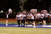 Hamilton High School football team taking the field with cheerleaders on both sides