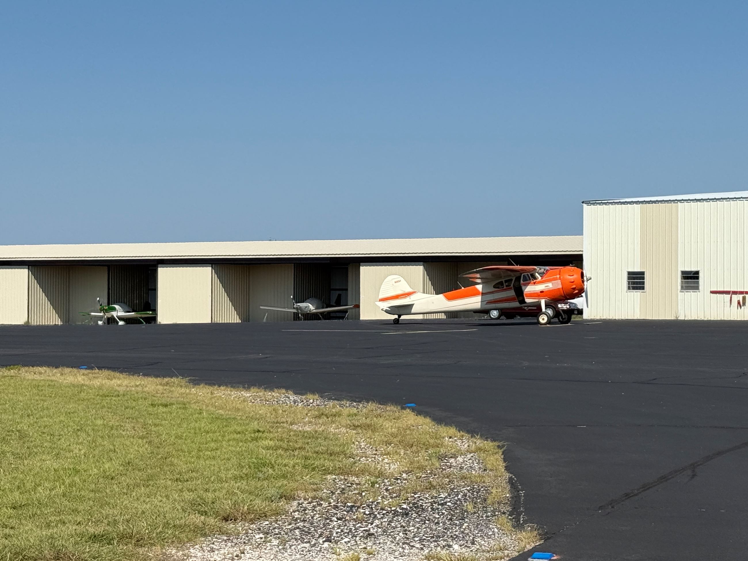 T-hangars with based aircraft on a sunny day.