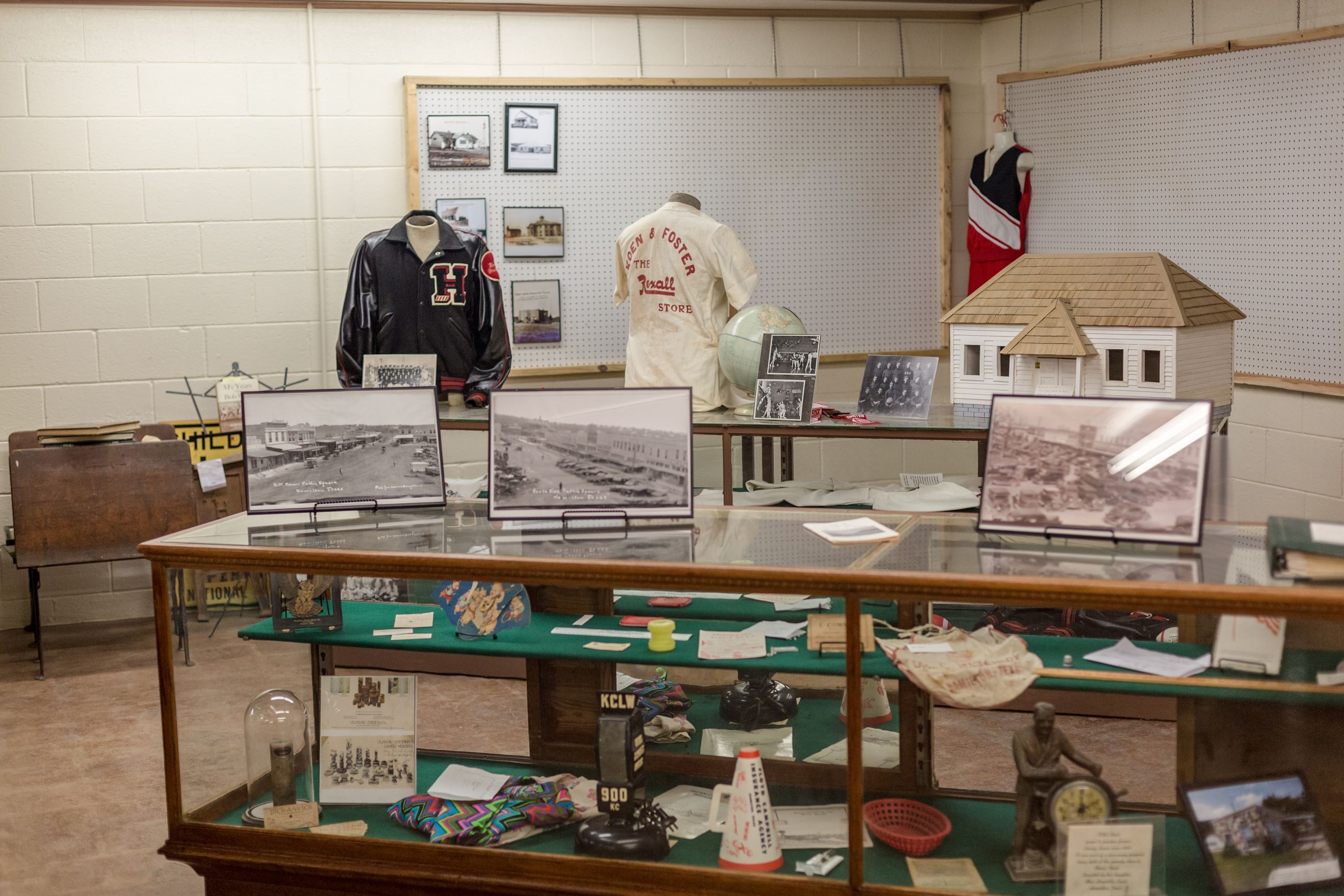 Military service display with uniform and U.S. flag in the museum.